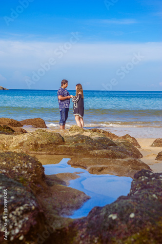 Joyful honeymoon couple playing on a beach in Phuket, Thailand