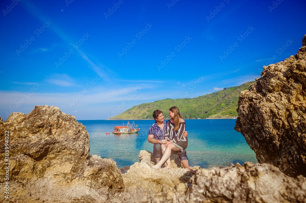 Joyful honeymoon couple playing on a beach in Phuket, Thailand