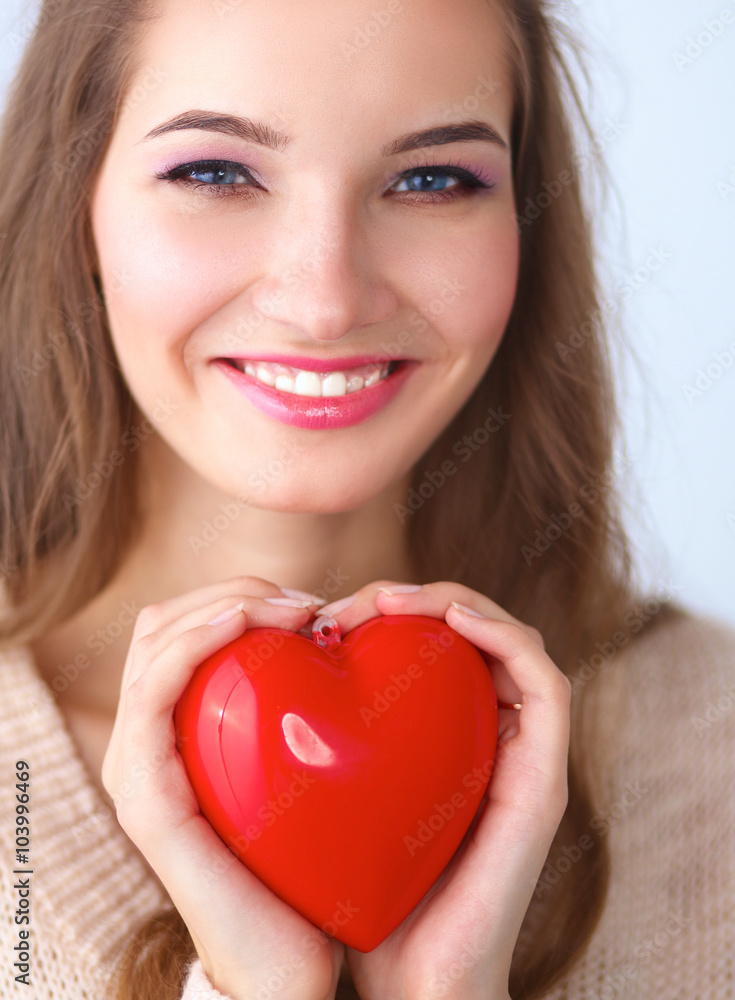 Portrait of beautiful happy woman holding a symbol heart. Portrait of beautiful happy woman holding a symbol heart.
