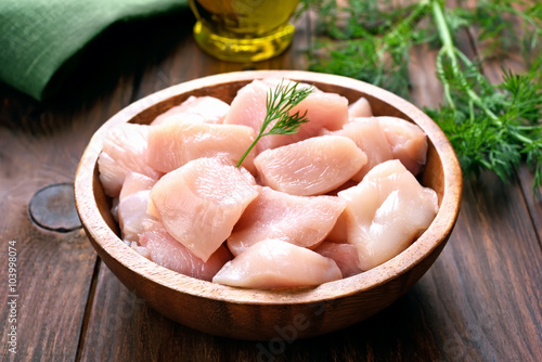 Chicken meat in wooden bowl