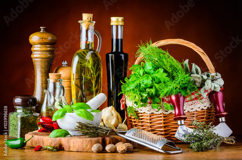 Fototapeta Naklejka Na Ścianę i Meble -  Green Herbs, Cooking Oil and Spices