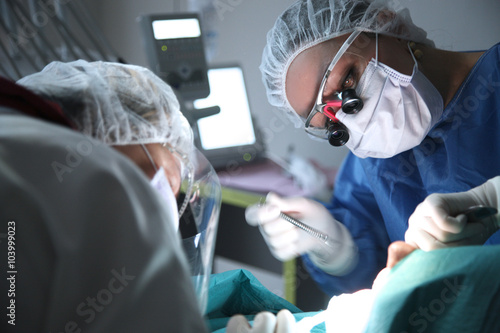 modern dental surgery, face of a female doctor working on a patient