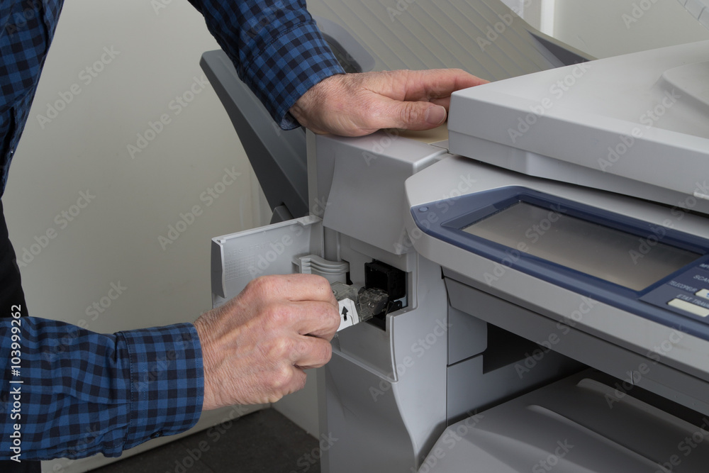 Man takes out black cartridge from white printer at work Man takes out black cartridge from white printer at work