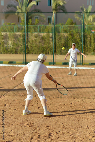 senior couple on tennis court