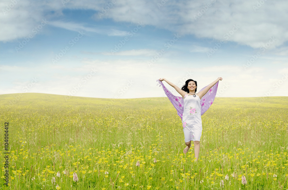 Pretty woman with fabric running on meadow Pretty woman with fabric running on meadow