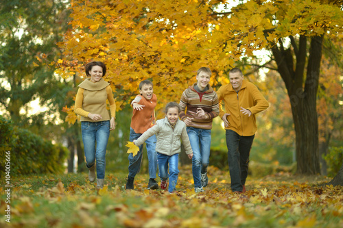 Family relaxing in autumn park