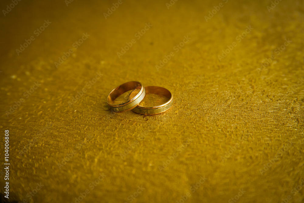 Wedding rings and flowers in the background uniform Wedding rings and flowers in the background uniform