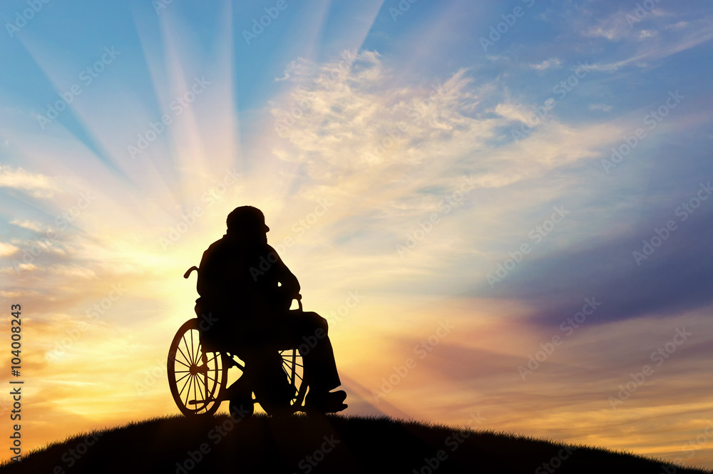 Fototapeta premium Silhouette of disabled person in a wheelchair
