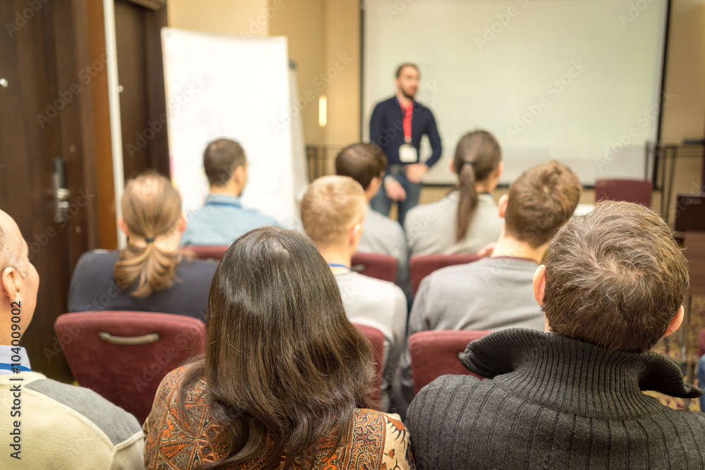Speaker Giving a Talk at Business Meeting. Audience in the conference hall. Business and Entrepreneurship. Speaker Giving a Talk at Business Meeting. Audience in the conference hall. Business and Entrepreneurship.