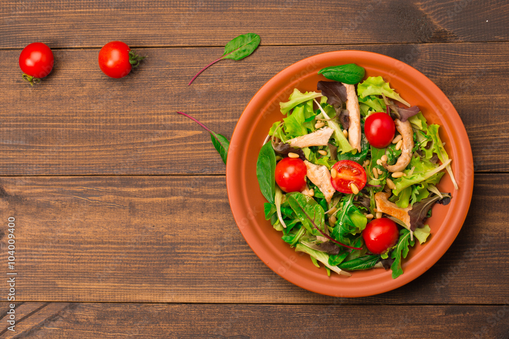 Fresh salad with chicken breast, arugula and tomato. Top view Fresh salad with chicken breast, arugula and tomato. Top view