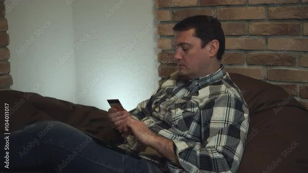 Attractive man making credit card purchases. Attractive man making credit card purchases.