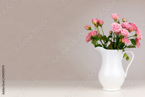 Fototapeta Naklejka Na Ścianę i Meble -  Pink flowers in white jug. Roses in jug.