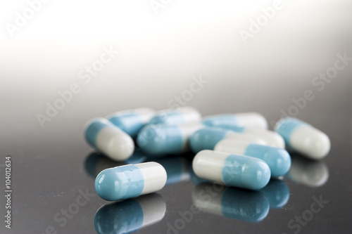 Blue medical capsules. Pharmaceutical medicament. Antibiotic, painkiller or narcotic, closeup.