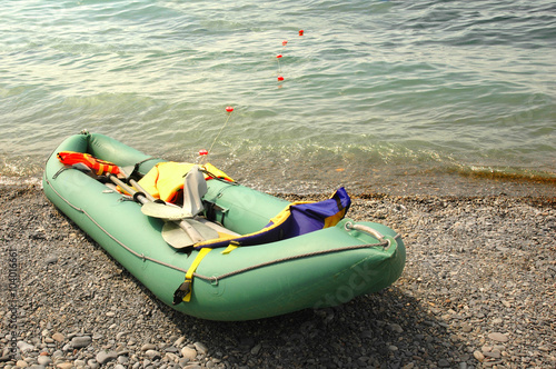 Green rubber boat on the beach
