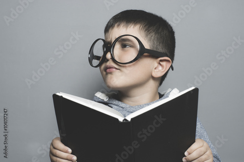 children, dark-haired young student reading a funny book, readin
