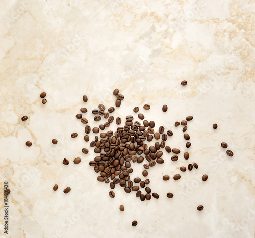 Coffee beans scattered on a marble background
