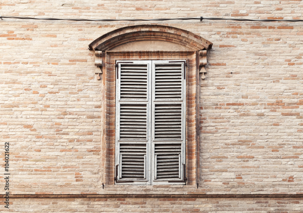 Old window shutters in ancient stone wall Old window shutters in ancient stone wall