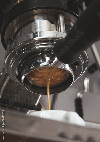 Close up creamy coffee drops from espresso machine © BublikHaus