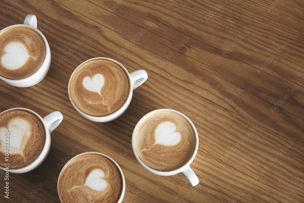 Six cappuccino cups isolated in corner Six cappuccino cups isolated in corner