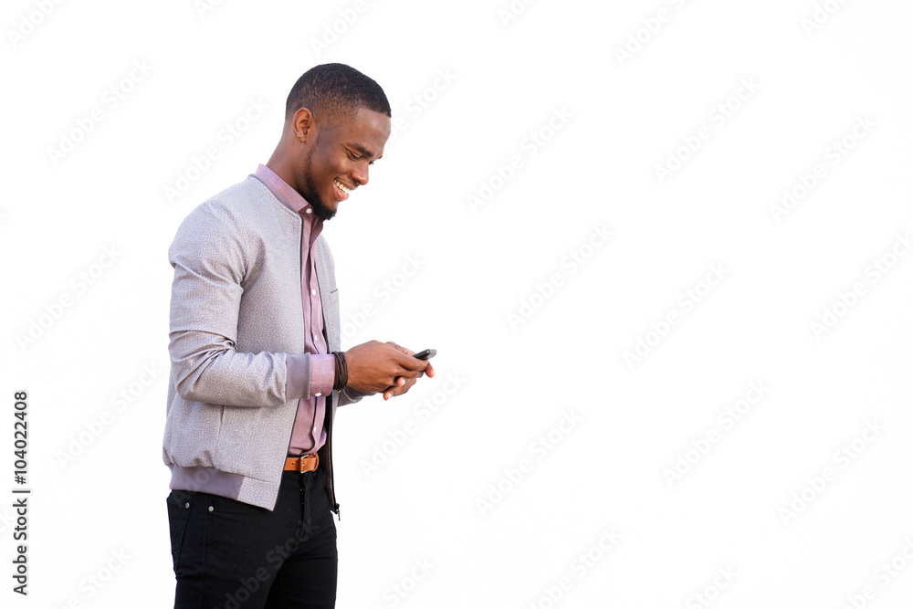 Cheerful young black guy sending text message Cheerful young black guy sending text message