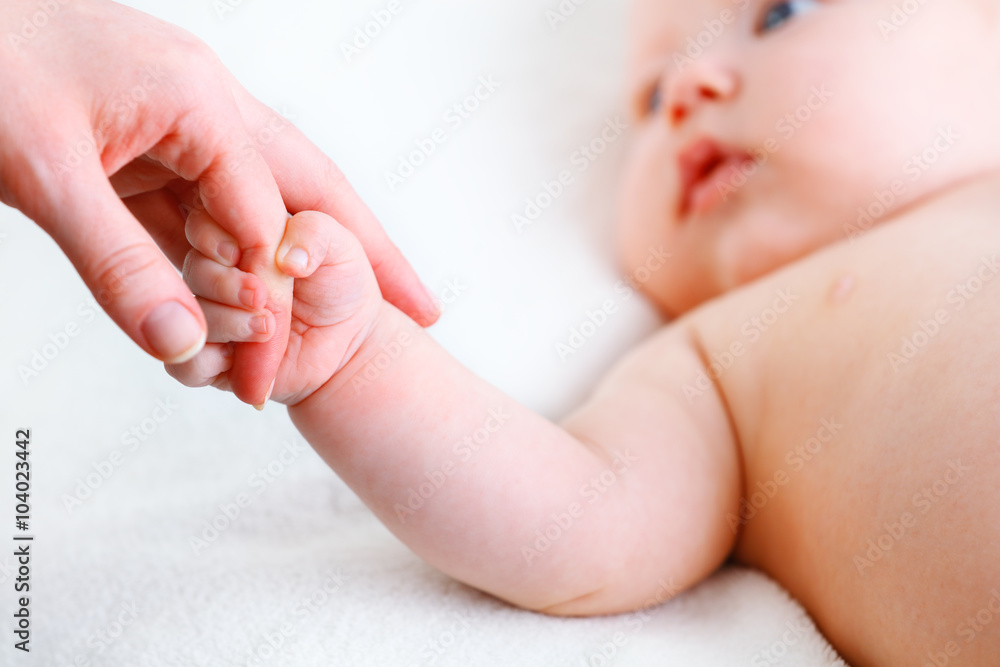 concept of parental love. baby hand holding finger of mother concept of parental love. baby hand holding finger of mother