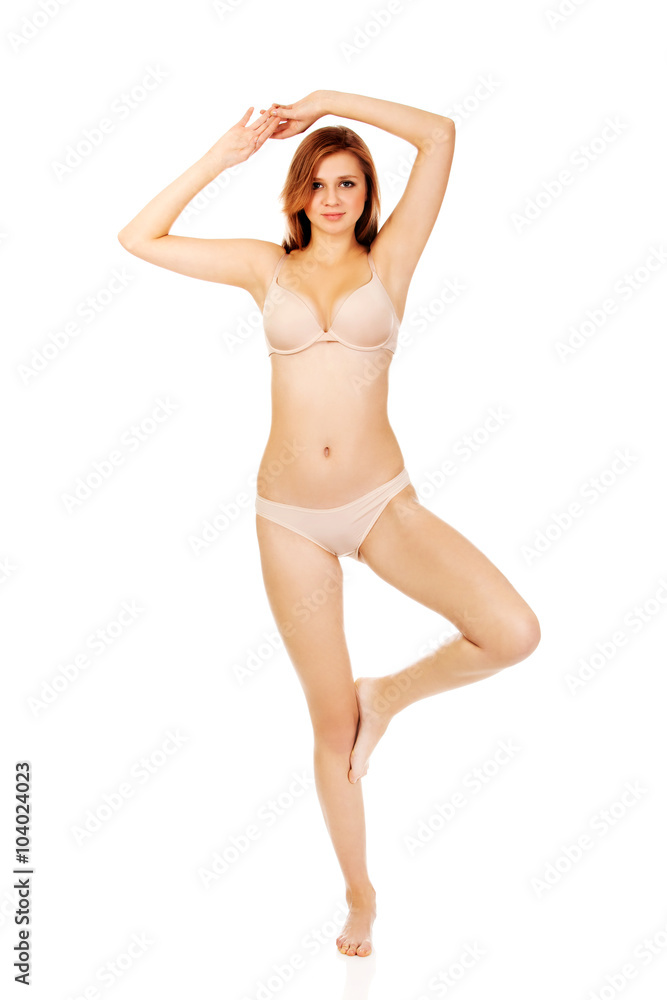 Young woman in underwear standing on one leg Young woman in underwear standing on one leg