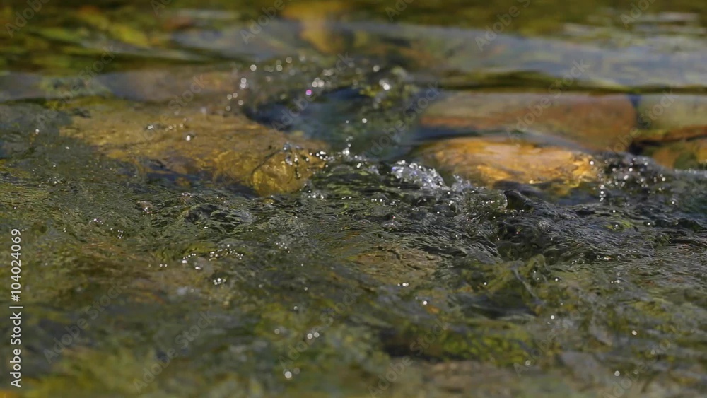 Water surface with ripples and sun rays reflections Water surface with ripples and sun rays reflections
