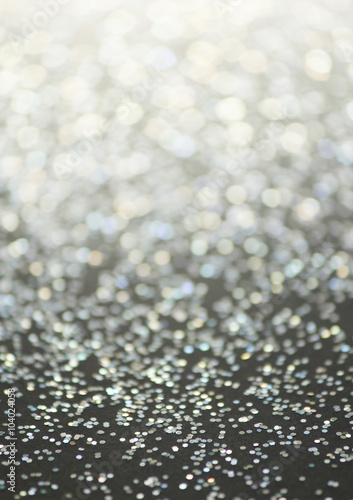 Unfocused abstract glitter holiday bokeh. silver golden lights. celebration card background.