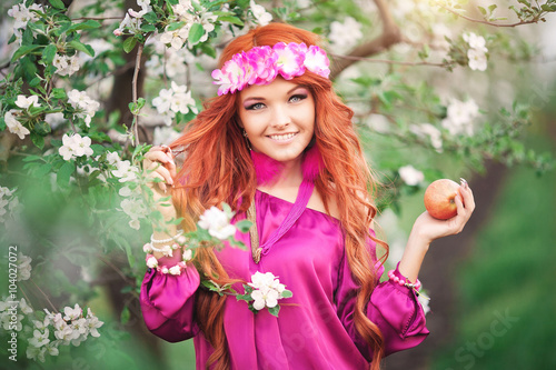 girl woman red-haired in spring garden apple