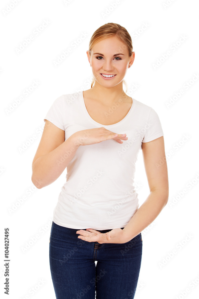 Young woman holding something between hands Young woman holding something between hands