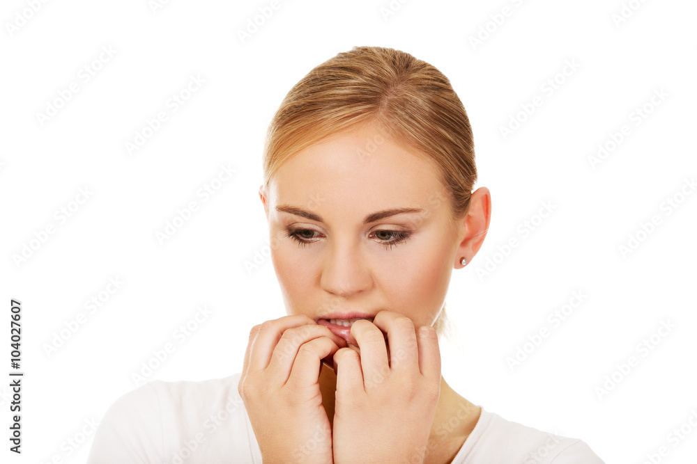 Stressed young woman biting nails Stressed young woman biting nails