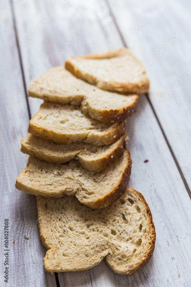 Sliced bread on wooden table Sliced bread on wooden table