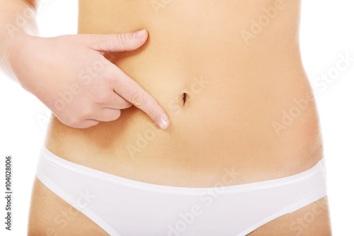 Woman pointing finger for her belly 