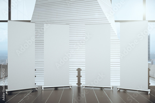 Blank posters on wooden floor in futuristic interior hall with b