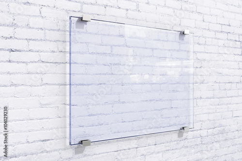 Blank glassy sighnboard on white brick wall, mock up photo