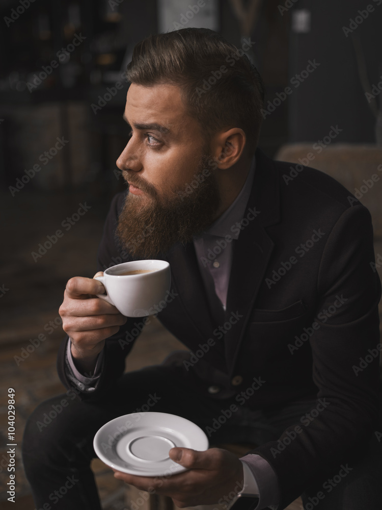 Attractive bearded businessman is resting in cafeteria Attractive bearded businessman is resting in cafeteria