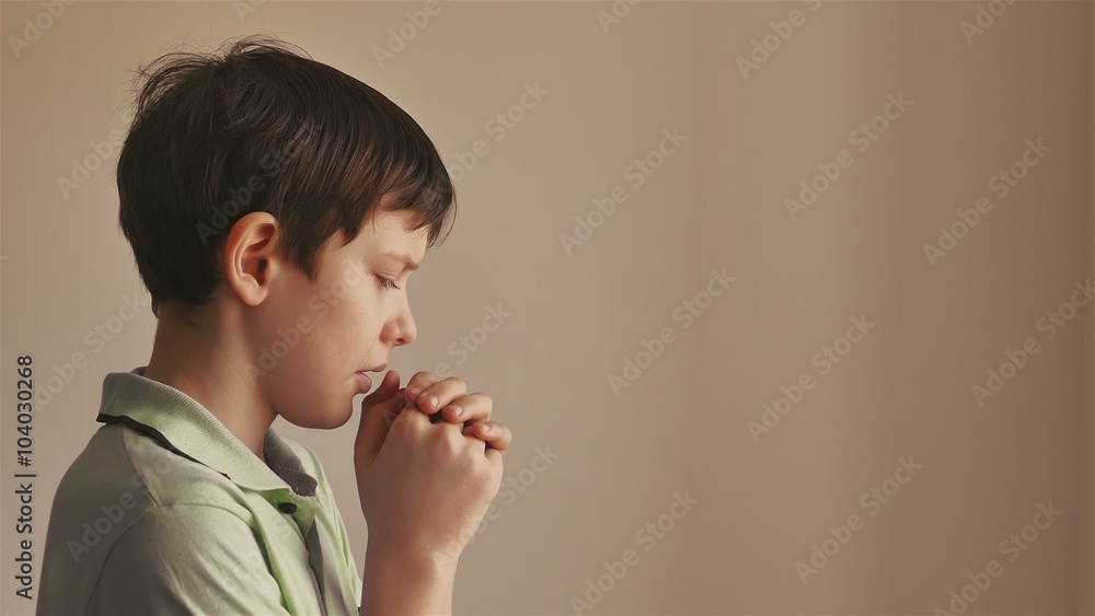 bot teen praying on a black background bot teen praying on a black background