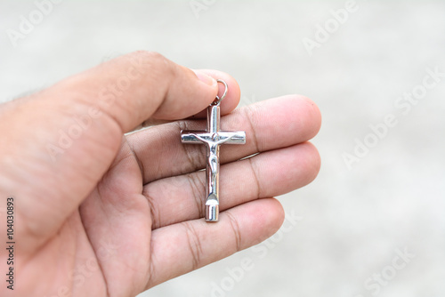 Necklace with a cross in hand