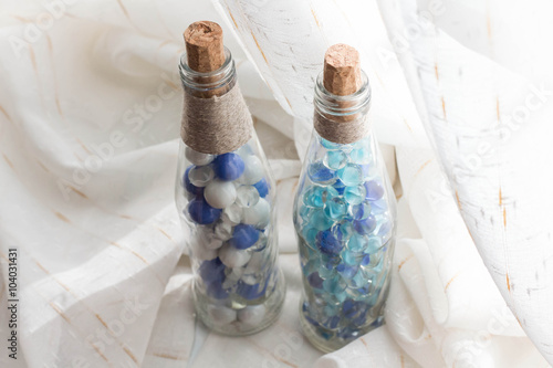 Blue marbles and glass bottles