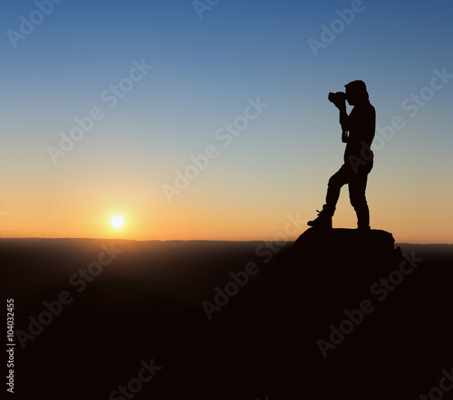 silhouette photographer at sunrise