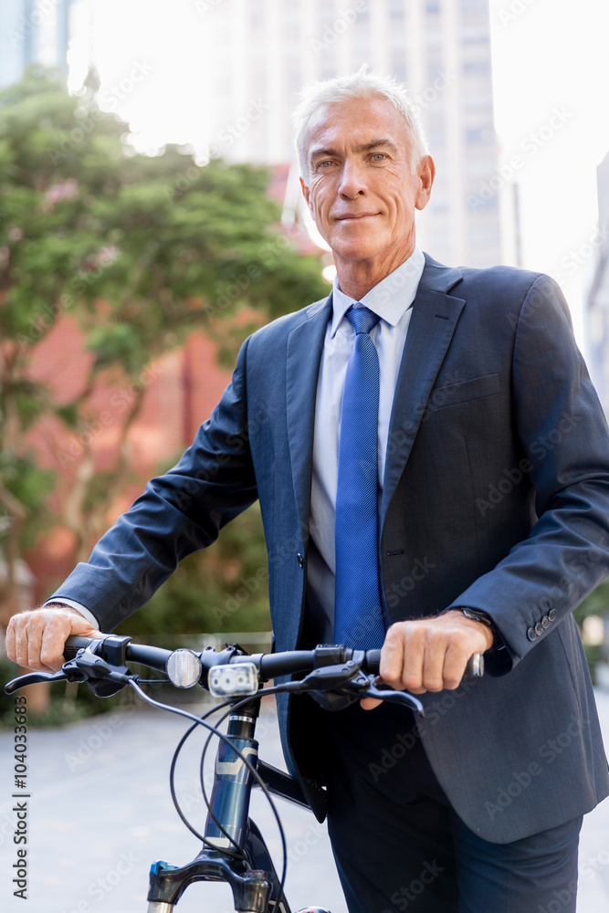 Successful businessman riding bicycle Successful businessman riding bicycle