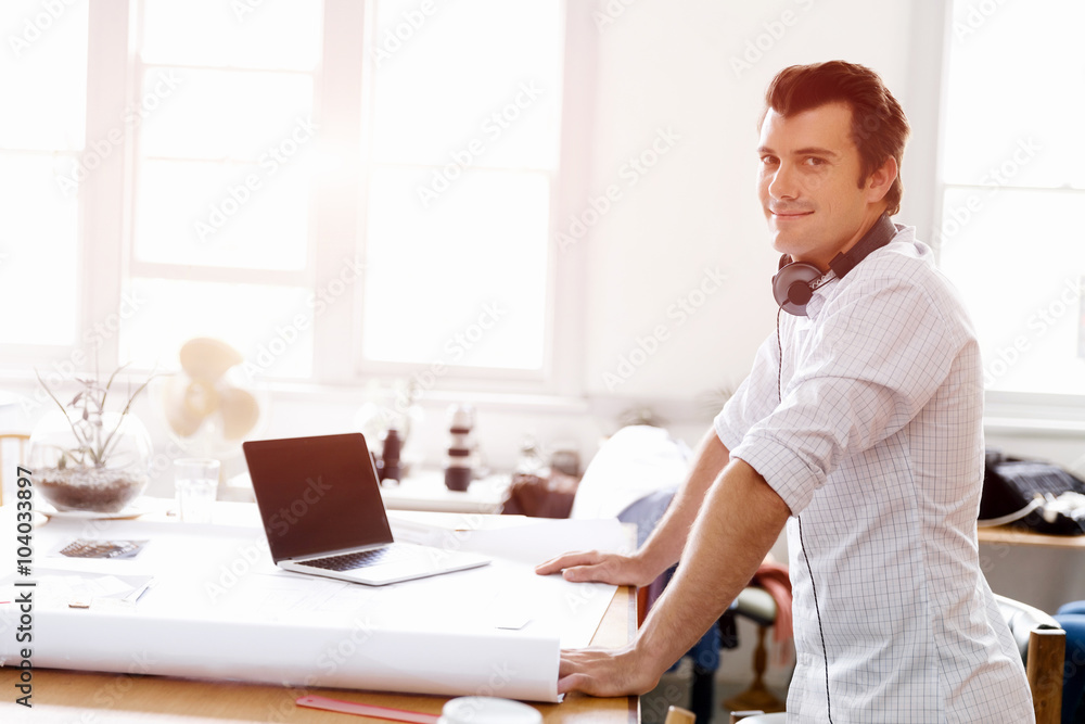 Young man standing in creative office Young man standing in creative office