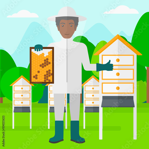Bee-keeper at apiary.