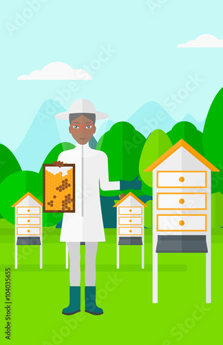 Bee-keeper at apiary.