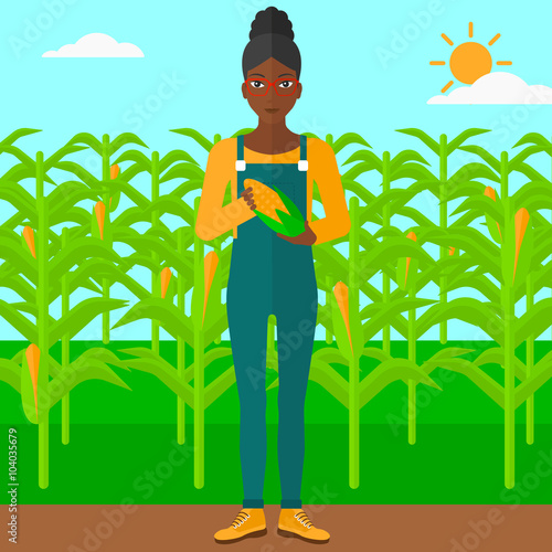 Farmer holding corn.