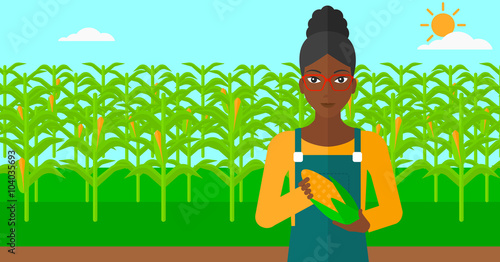 Farmer holding corn.