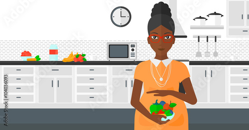 Pregnant woman with vegetables.