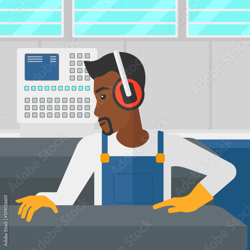 Man working on steel-rolling mill.
