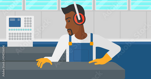 Man working on steel-rolling mill.