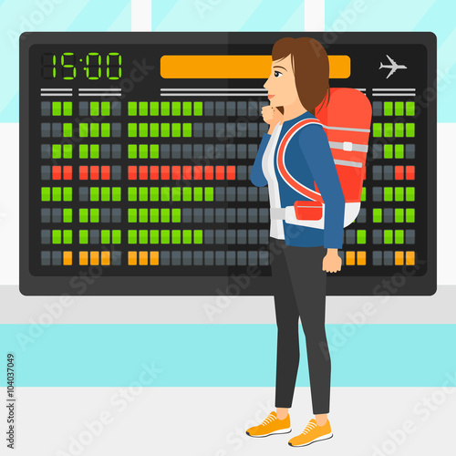 Woman looking at schedule board.